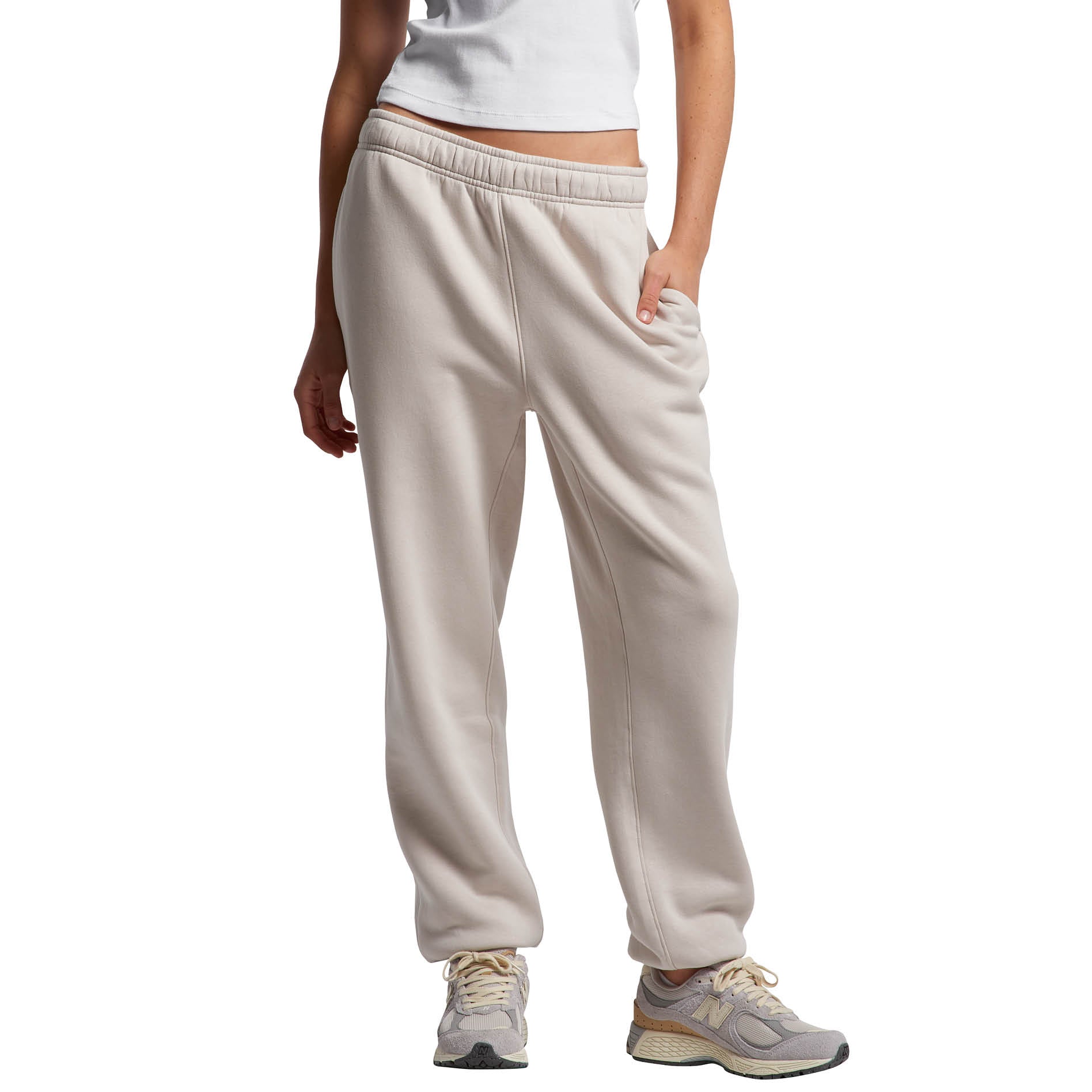 Person wearing bone coloured pants on a white background. Normalize Neurodivergence.